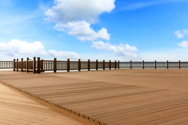 istock Lakeside wood floor platform and blue sky with white clouds 1144274791