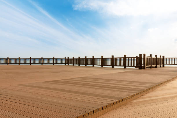 istock Lakeside wood floor platform and blue sky with white clouds 1144274865