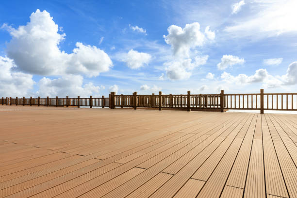 istock Lakeside wood floor platform and blue sky with white clouds 1144274886