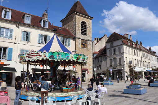 City of Lons Le Saunier - Department of Jura - France Square of Freedom - Central Square of the city - Children's carousel - Children turning on the ride