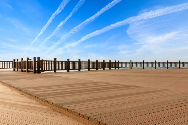 istock Lakeside wood floor platform and blue sky with white clouds 1144274942