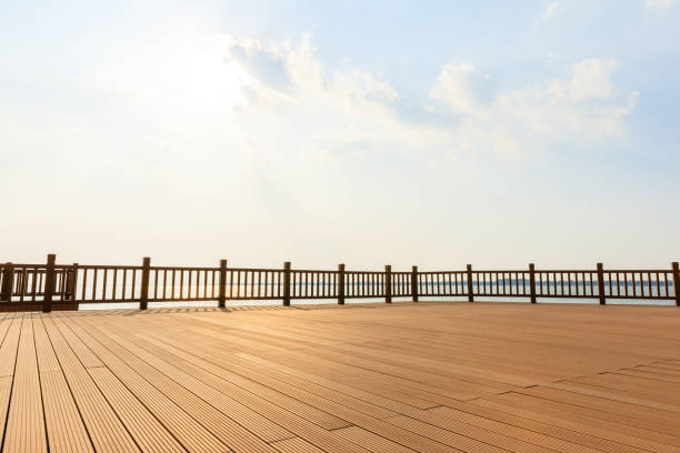 istock Lakeside wood floor platform and blue sky with white clouds 1144275026