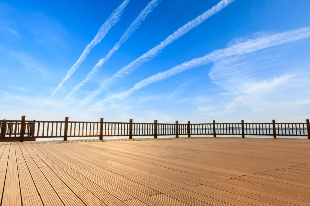 istock Lakeside wood floor platform and blue sky with white clouds 1144275061