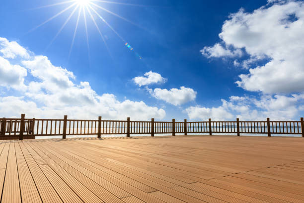 istock Lakeside wood floor platform and blue sky with white clouds 1144275130