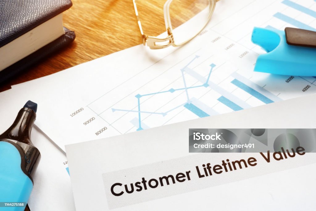 Customer lifetime value CLV or CLTV report papers. Making Money Stock Photo
