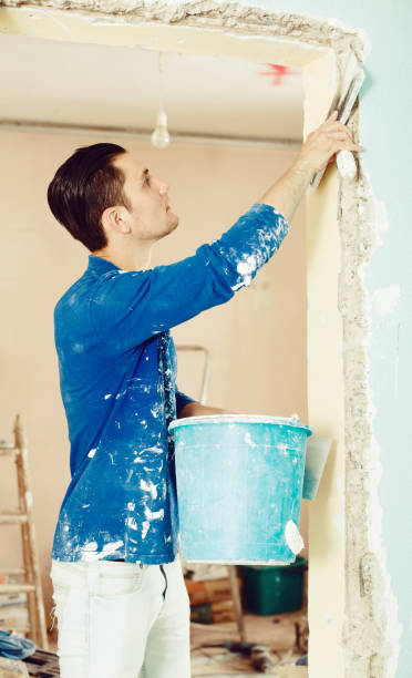 istock Plasterer renovating indoor doorway 1144276493