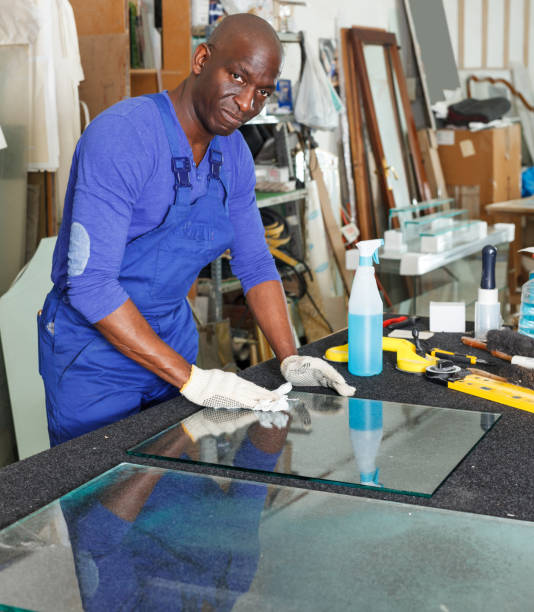 istock workman cleaning cut glass at workplace 1144277325
