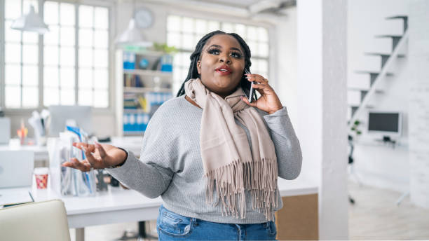 istock Afro woman talking on a smart phone at work 1144279179