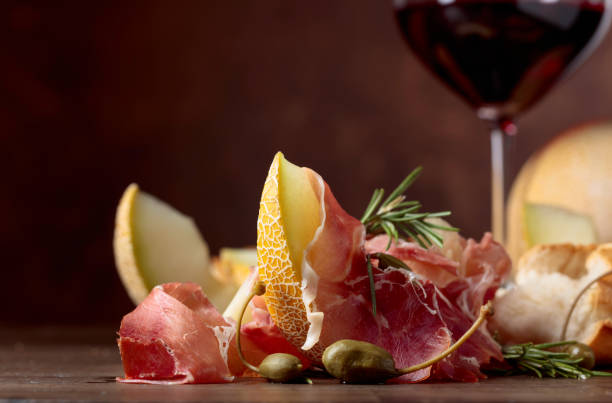 istock Prosciutto with melon, capers and rosemary. 1144281691