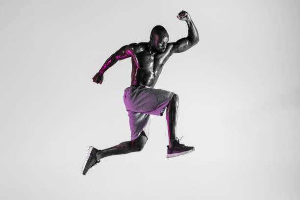 istock Young african-american bodybuilder training over grey background 1144281888