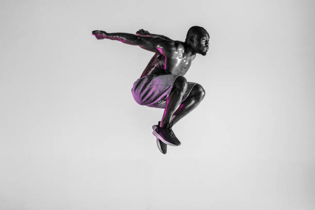 istock Young african-american bodybuilder training over grey background 1144281891