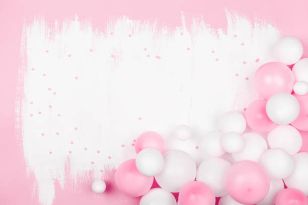 istock Creative painted background with white pink balloons and confetti. Top view and flat lay. Birthday or party concept. 1144283139