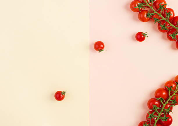 istock Isolated fresh red cherry tomatoes on yellow-beige background. Top view. Flat lay 1144283465