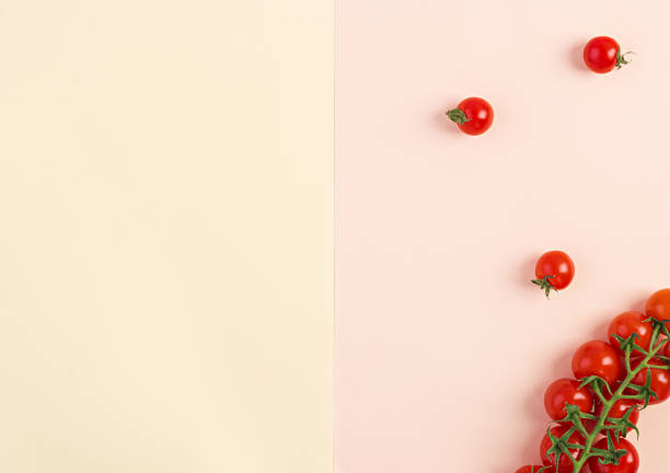 istock Isolated fresh red cherry tomatoes on yellow-beige background. Top view. Flat lay 1144283471