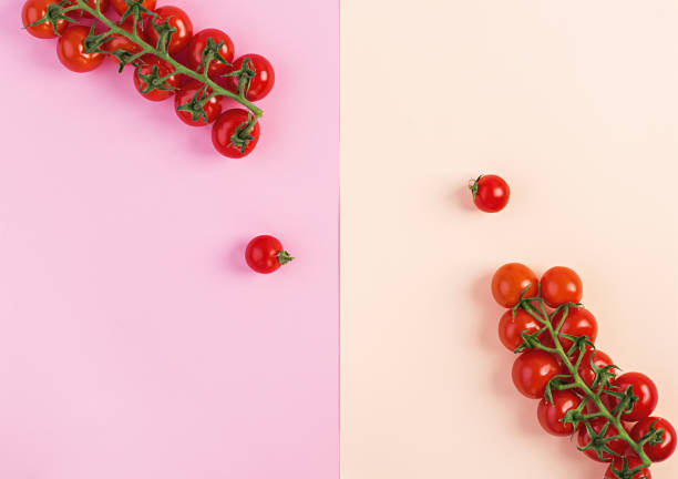 istock Isolated fresh red cherry tomatoes on pink-beige background. Top view. Flat lay 1144283477