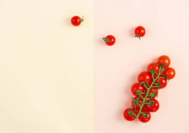 istock Isolated fresh red cherry tomatoes on yellow-beige background. Top view. Flat lay 1144283480