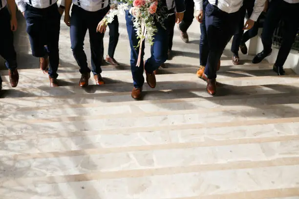 Bridegroom with groomsmen walking