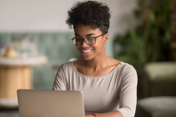 istock Happy african american woman using laptop work study in office 1144287276