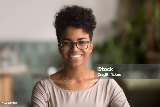 Headshot Portrait Of Happy Mixed Race African Girl Wearing Glasses Stock Photo - Download Image Now