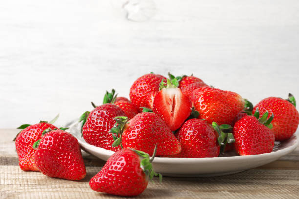 istock Fresh strawberries in plate on wood 1144288902