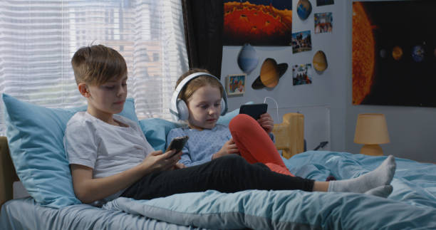 istock Boy and girl relaxing together on bed 1144293945