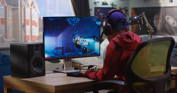 Medium shot of a boy playing with a first-person shooter video game