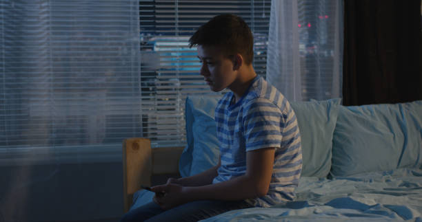 istock Boy sitting alone in bedroom 1144294570