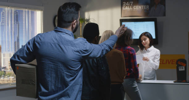 customer complaining about slow service in delivery center - women customer service representative service standing imagens e fotografias de stock