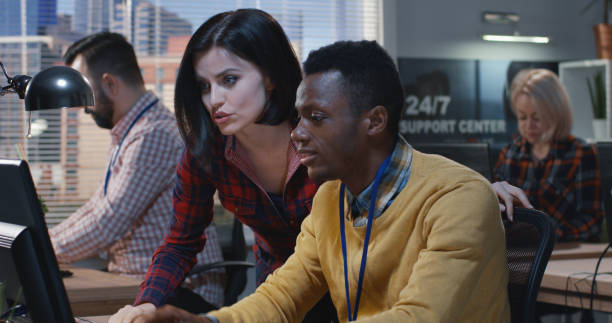 istock Young woman helps colleague 1144295928