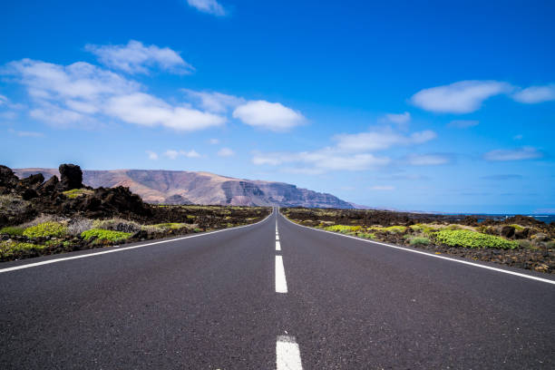 istock Spain, Lanzarote, Endless bolt upright highway and perfect blue sky 1144295996