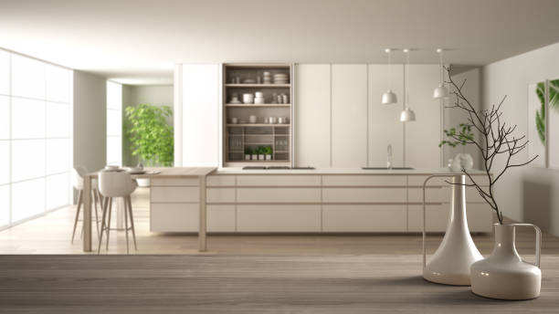 istock Wooden table top or shelf with minimalistic modern vases over blurred modern white kitchen with wooden details and parquet floor, minimalist architecture interior design 1144296153