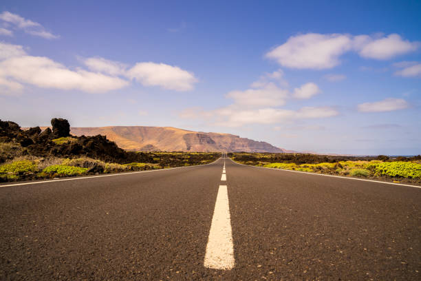 istock Spain, Lanzarote, Bolt upright highway through beautiful scenery 1144296383