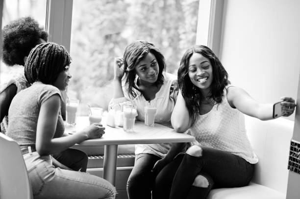 istock Four young african girls in bright colored restaurant 1144297213