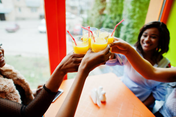 istock Four young african girls in bright colored restaurant 1144297316