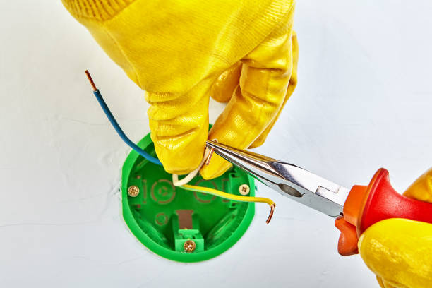 istock Long nose pliers mounts round electrical box. 1144300296