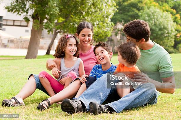 Happy Family Having Fun In The Park Stock Photo - Download Image Now - Family, Happiness, Adult