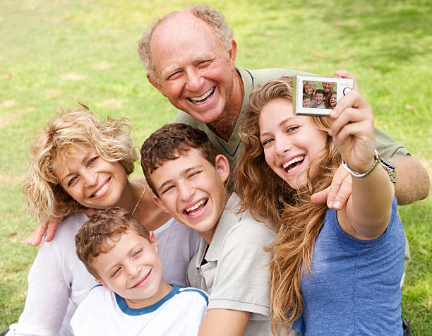 istock Family outdoors taking self portrait 114430112