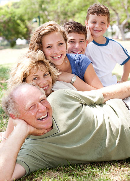 istock Multi-generation family realxing in park 114430171