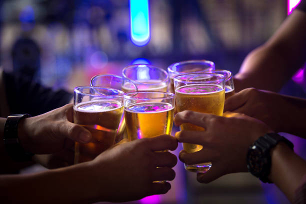 Group of  young people hands toasting and cheering aperitif beers half pint Group of  young people hands toasting and cheering aperitif beers half pint hostel photos stock pictures, royalty-free photos & images