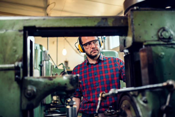 istock Machinist operate gear cutting machine at factory 1144302486