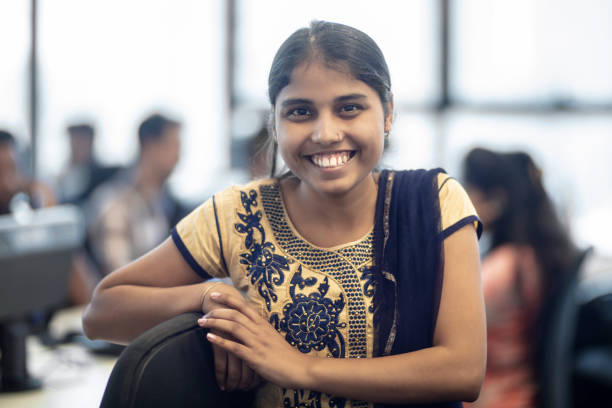 istock Smiling young businesswoman standing at workplace 1144302806