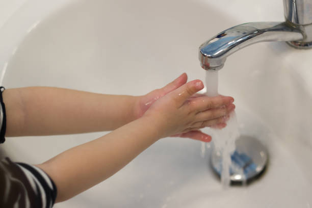 Child hand washing in the washbasin