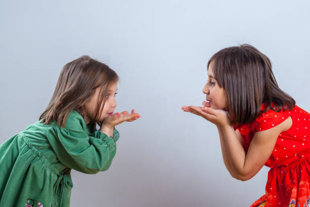 istock two little sisters posing for the camera in the studio 1144304212