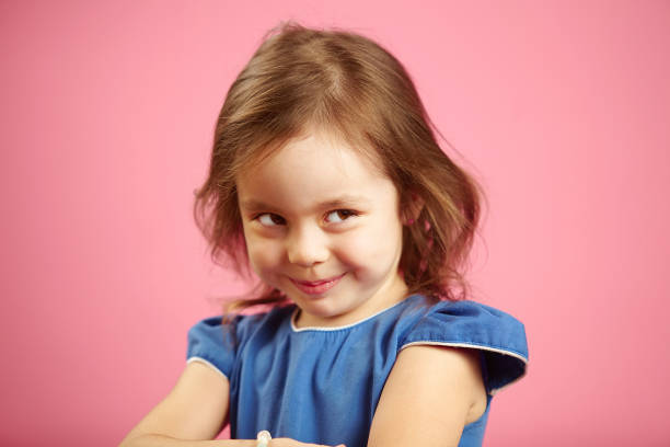 istock Cunning girl with a curious look looks to the side and is plotting something. 1144304809
