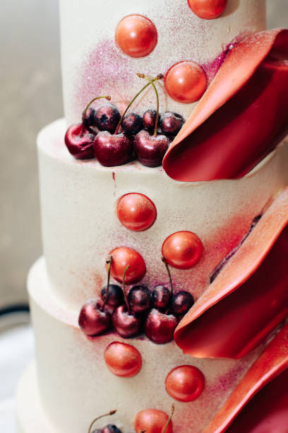 istock beautiful big three-story cherry-colored wedding cake one 1144307286