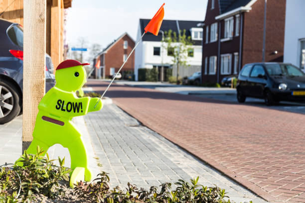 Slow traffic sign in subsurban neigbou Warning sign in a family friendly suburban neighborhood to warn drivers to drive slowly because children are playing in the steet. northern europe family car stock pictures, royalty-free photos & images