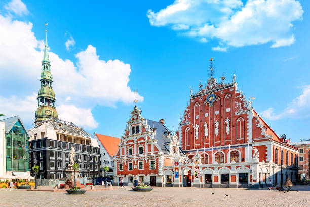 View of the Old Town Ratslaukums square, Roland Statue, The Blackheads House near St Peters Cathedral against blue sky in Riga, Latvia. Summer sunny day View of the Old Town Ratslaukums square, Roland Statue, The Blackheads House near St Peters Cathedral against blue sky in Riga, Latvia. Summer sunny day. latvia stock pictures, royalty-free photos & images