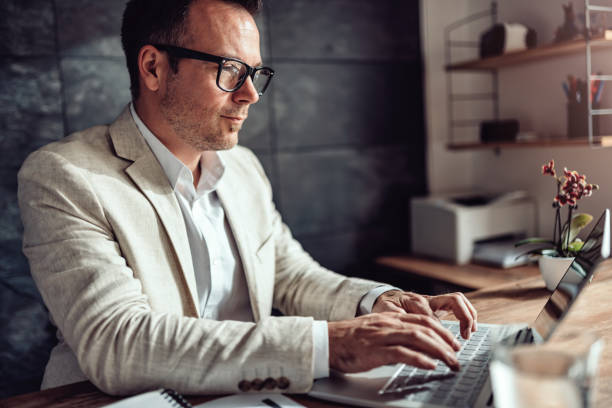istock Businessman sitting at his desk and using laptop in the office 1144311113
