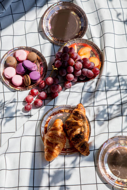 istock Grape, macarons and croissants on plates 1144311773