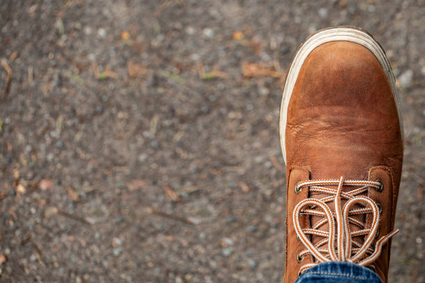 istock Orange brown mens autumn boots on a asphalt background. Top view, copy space 1144312836